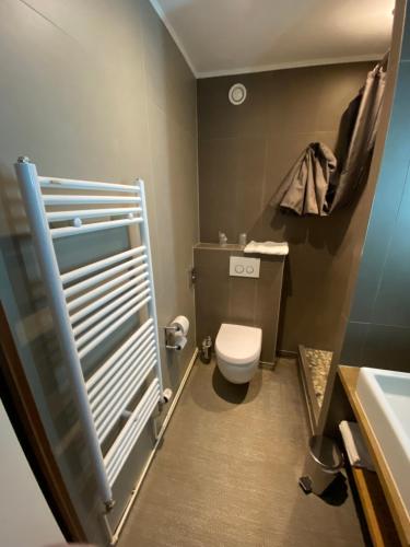 a small bathroom with a toilet and a sink at Enzo Hôtels - ST Eloy Metz Amneville By Kyriad Direct in Amnéville