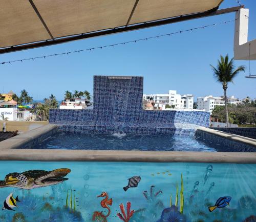 una pintura de una piscina con una fuente en Los Bungalitos en Rincon de Guayabitos