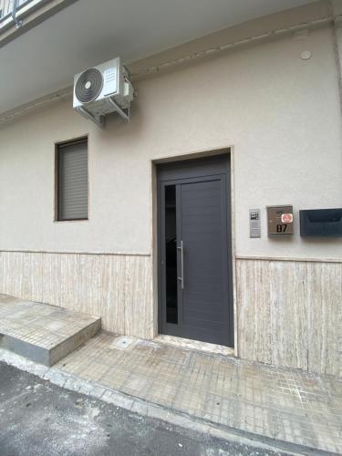 a building with a door and a speaker on it at Casangiù in Crispiano