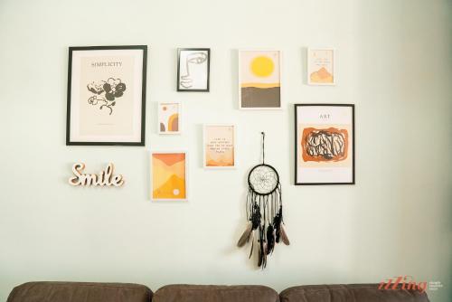 a wall with pictures and a clock on it at A seaside holiday home with country views in Żebbuġ