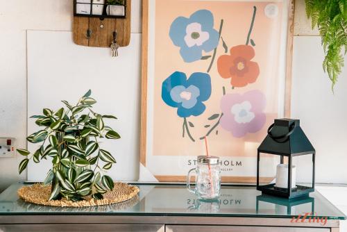 a glass table with two plants and a lamp at A seaside holiday home with country views in Żebbuġ