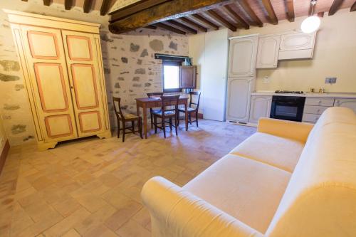 a living room with a couch and a table at Borgo Colognola - Dimora Storica in Cenerente