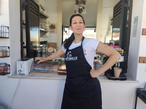 a woman standing in front of a counter at La Gitanilla Alojamiento & Encanto Jerez in Jerez de la Frontera