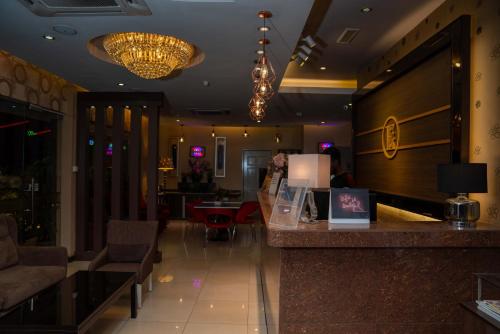 a bar in a restaurant with chandeliers at Hotel Eastana Ipoh in Ipoh