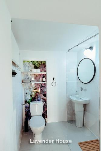 a bathroom with a toilet and a sink at Lavender House in Osieki