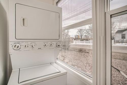 a kitchen with a white refrigerator next to a window at Ranch Style Home Playretreat 6 Mi Denver in Wheat Ridge