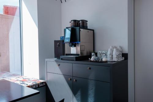 a kitchen with a coffee maker on top of a dresser at Das Edlinger in Salzburg