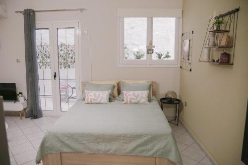 a bedroom with a large bed with two pillows at Just A Stay apartement in Chios