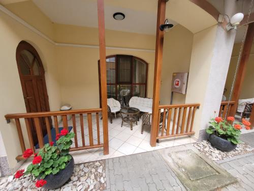 a balcony of a house with two plants at Penzión Korzo in Štúrovo