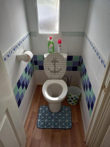 a small bathroom with a toilet with an anchor on it at Bluebell chalet in Leysdown-on-Sea