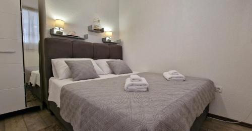 a bedroom with a bed with two towels on it at Soft apartment in Solin next to Split in Solin