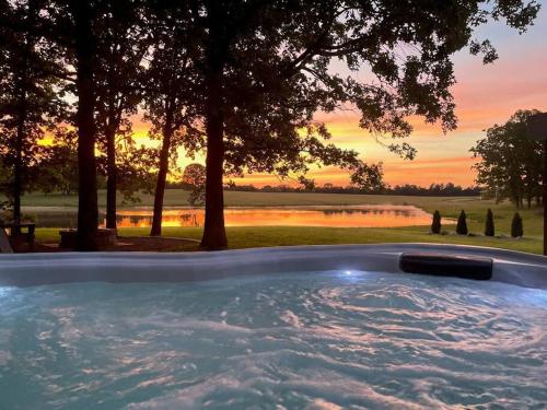 a hot tub with a sunset in the background at the evergreene in Fredericktown
