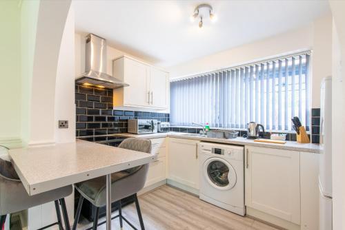 a kitchen with a sink and a washing machine at 1BR Derby City Centre Flat 1 - Charnwood Flats in Derby