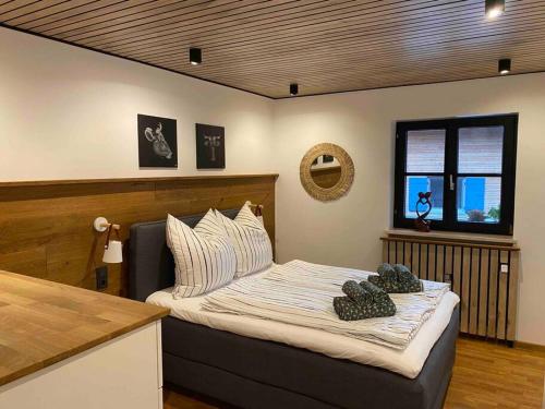 a bedroom with a bed with two pillows on it at Cozy, modern and chic mit Bergblick in Ofterschwang
