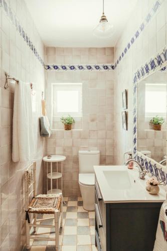 a bathroom with a sink and a toilet and a mirror at Dehesa de la yeguas-Finca privada con piscina a 15 min playas in Cádiz