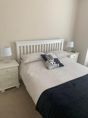 a bedroom with a large bed with two night stands at Angies Place in Midhurst