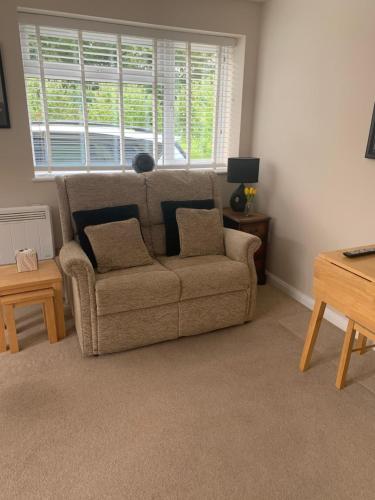 a living room with a couch and a window at Angies Place in Midhurst