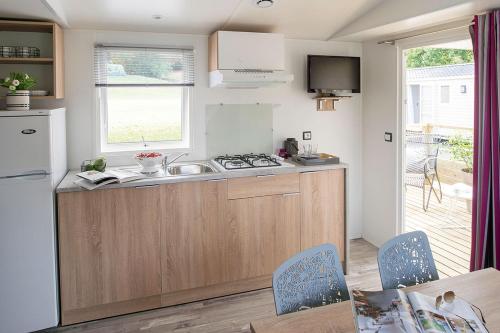 a kitchen with a sink and a counter top at Camping de Brouël in Ambon