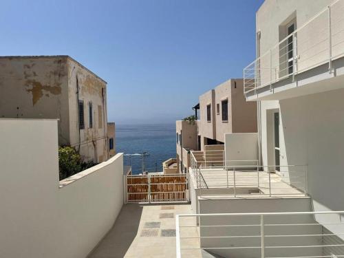 a row of buildings with the ocean in the background at Fenici Levanzo - Island Apartments in Levanzo