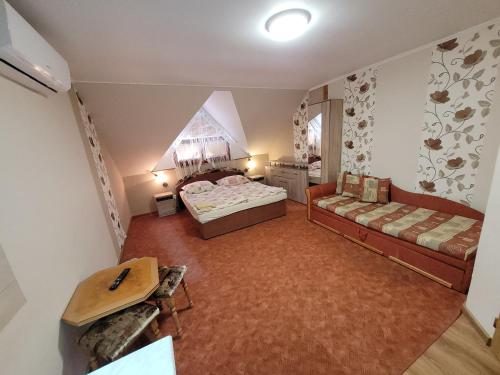 an overhead view of a bedroom with two beds and a table at Penzión Korzo in Štúrovo