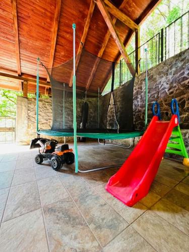 a playground with a slide and a red slide at Casa Ana in Moneasa