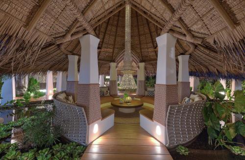 a lobby of a resort with a table and chairs at Nay Palad Hideaway - All Inclusive Stay in General Luna