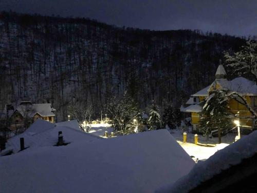 a house covered in snow at night at Casa Ana in Moneasa