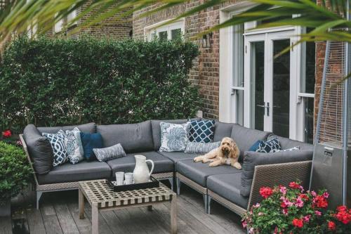 a dog laying on a couch on a patio at Little Venice 3 bed with Private Terrace in London