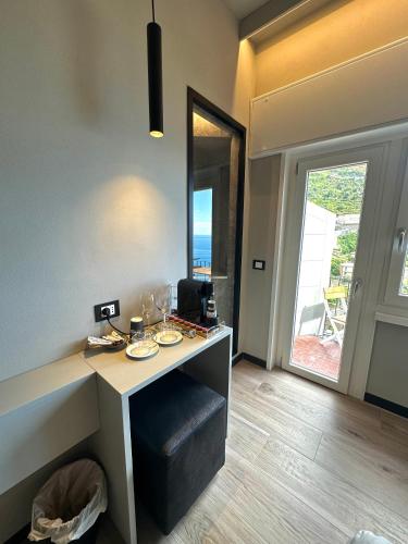 a room with a counter with a table and a window at The Upper House in Riomaggiore