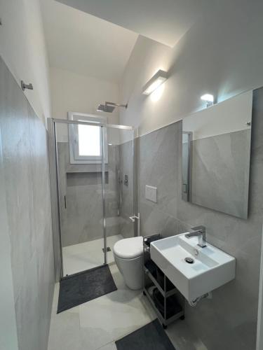 ein Badezimmer mit Waschbecken, Toilette und Dusche in der Unterkunft Villa Giuliana Luxury Home: piscina, solarium, barbecue. A pochi passi dal mare in Fontane Bianche