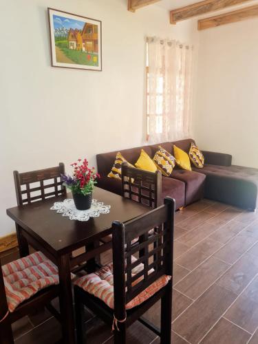 a living room with a table and a couch at La Cabaña de Mari in Oxapampa
