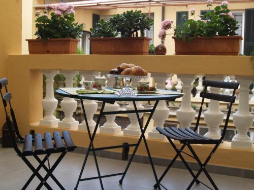 a table with a plate of food on a balcony at B&B Casa Trucchi in Ventimiglia