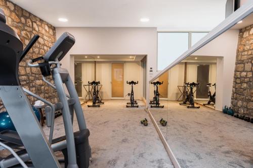 a gym with exercise equipment in a building at Heritage Grand Perast By Rixos in Perast