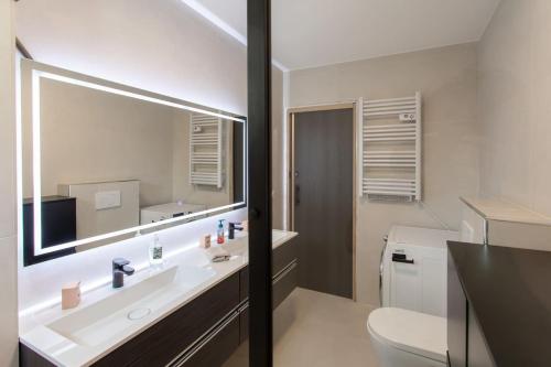 a bathroom with a sink and a toilet and a mirror at Villa modern Super-Cannes heated Pool, Parking, CLIM, 7 min to Cannes Beach in Vallauris