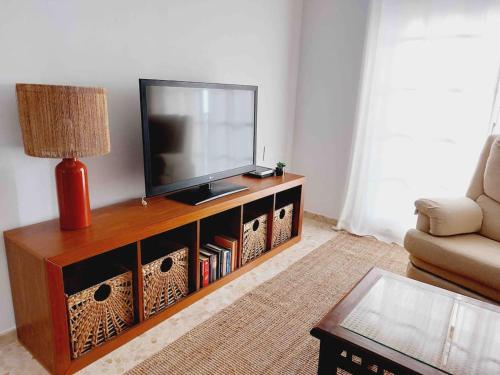 a living room with a flat screen tv on a entertainment center at TORRE DEL MAR DELUXE CLOSE TO BEACH & PARKING Sinese Design Homes in Torre del Mar