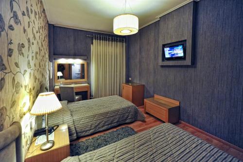 Postel nebo postele na pokoji v ubytování Haikos Hotel