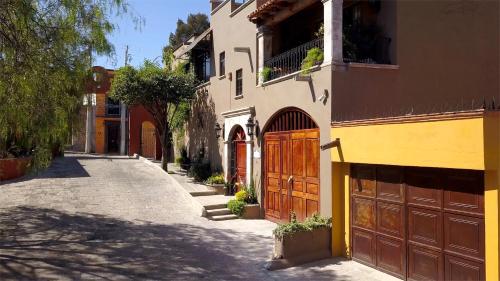 una calle vacía con un edificio con garaje en Casa Grande Luxury Boutique Hotel, en San Miguel de Allende