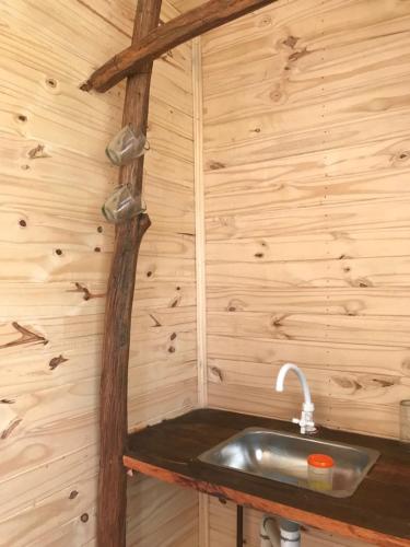 a bathroom with a sink in a wooden wall at Campo verde II in Concordia