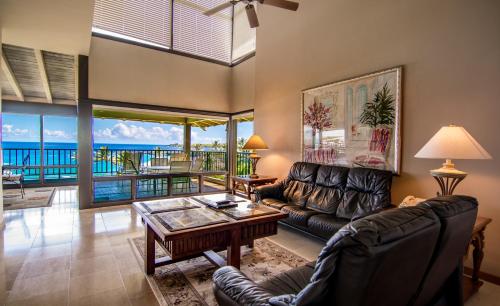 a living room with a couch and a table at Kapalua Villas Maui - Select Your Unit in Kahana