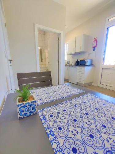 a kitchen with a table with a potted plant on it at Funchal Apartments - New Botanic Garden Petit Studios in Funchal