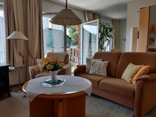 a living room with a couch and a table at Landhaus Heide in Schneverdingen