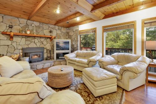 a living room with couches and a stone fireplace at 2321-Knickerbocker Retreat chalet in Big Bear Lake