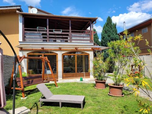 a house with a yard with a swing at Penzión Korzo in Štúrovo