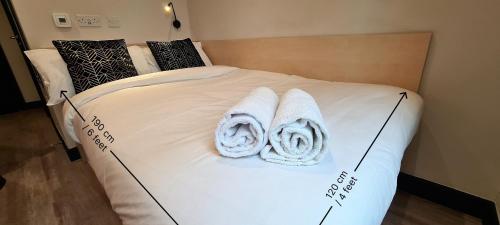 a bed with two towels on top of it at ALTIDO Affordable Dublin Parkgate - Adults only in Dublin
