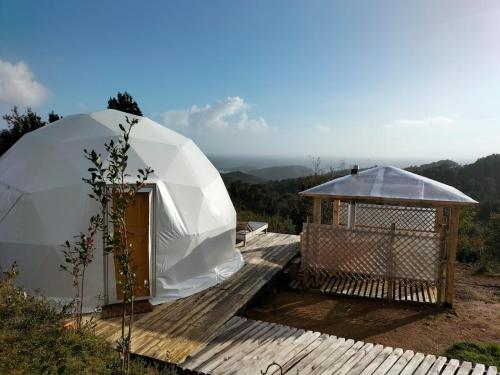 a dome tent and a gazebo on a wooden deck at Domo con tinaja, Estaquilla in Los Muermos