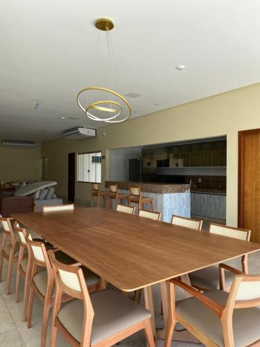 a large wooden table and chairs in a room at Maper Ouro in Parauapebas