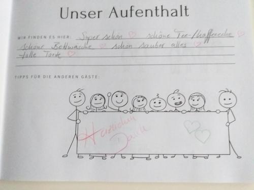 a paper with a drawing of a group of people at Neubau Appartement mit Terasse, privater Eingang,Parkplatz,Küche in Fürth