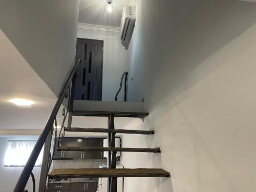a staircase in a building with a stair case at Apart-Hotel Vasilisa EVN Airport in Pʼarakʼar