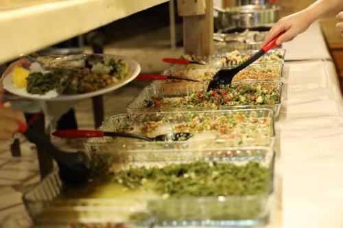 a buffet line with many plastic containers of food at Simurg Evleri Olympos in Olympos