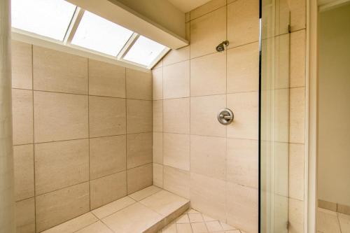 a bathroom with a shower with a skylight at Kapalua Villas Maui - Select Your Unit in Kahana
